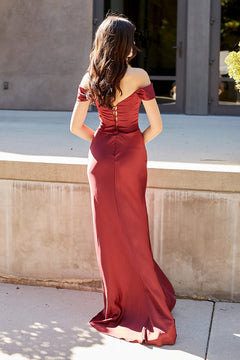Back view of a person wearing a maroon, off-the-shoulder Amelia Couture 6151 floor-length gown with a lace-up corset bodice.