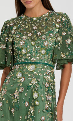 Green dress with floral embroidery on a white background