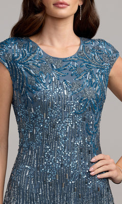 Woman in the Beaded Long Lilac Formal Dress, Mac Duggal 6169, embellished with intricate beadwork and sequins, stands with one hand on her hip; her face is partially out of view.