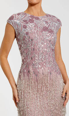 A woman wears the Beaded Long Lilac Formal Dress (Mac Duggal 6169), featuring bead and fringe detailing, reminiscent of a glamorous evening gown.