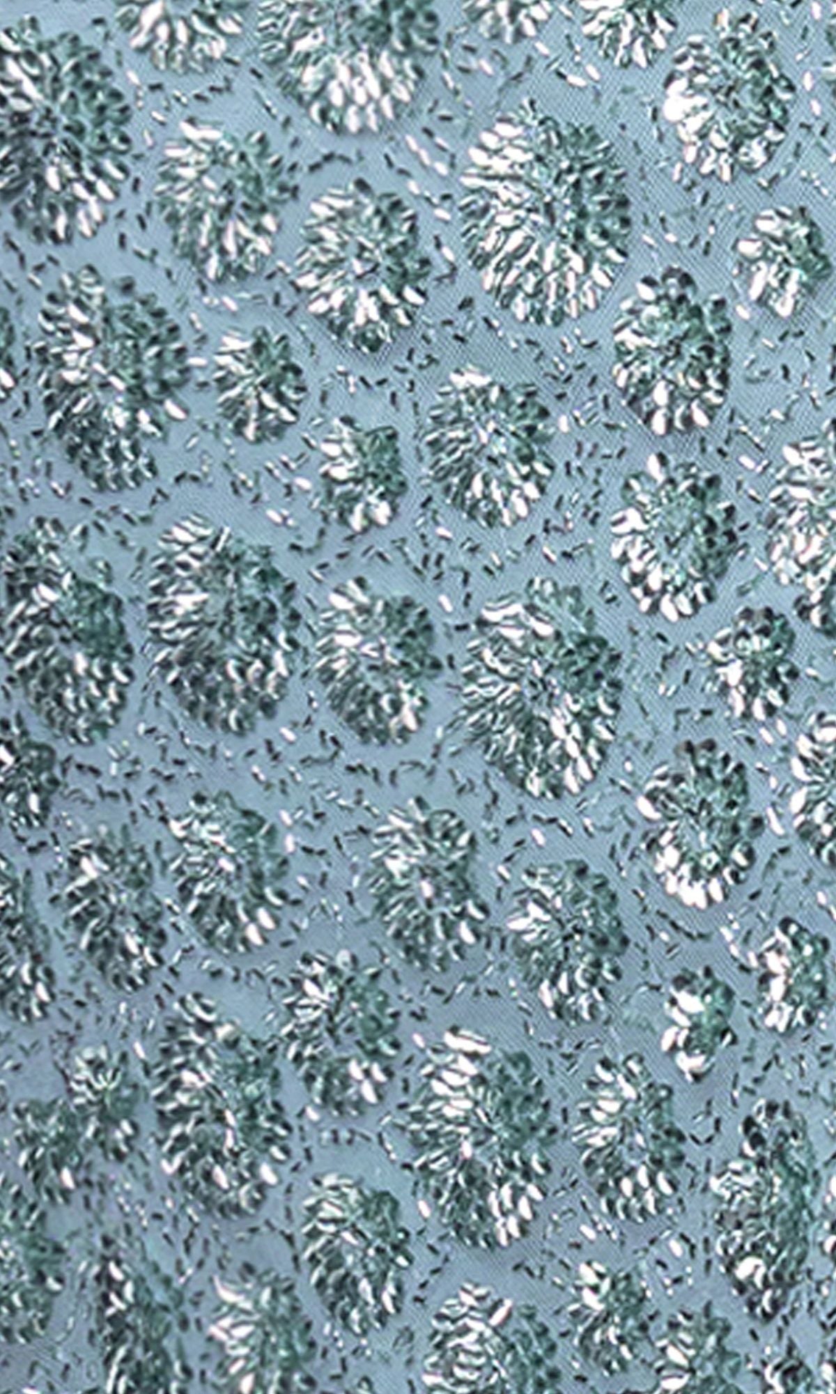 Close-up of the Long Prom Dress: Blondie Nites 6171BN, showcasing textured fabric with metallic silver and teal raised circles and beadwork on a light blue background—perfect for prom.