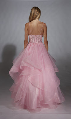 A woman in the Alyce 61731 Long Prom Dress, featuring a lace embroidered corset and thin straps, faces away from the camera as her light pink layered tulle gown flows elegantly against a plain backdrop.