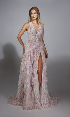 A woman models the Alyce 61740 long prom dress—a light pink gown with a plunging neckline, high slit, ruffled layers, and sparkling floral embellishments—set against a neutral background.