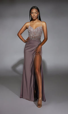 Woman wearing the Alyce 61741 Beaded-Lace-Corset Long Prom Dress, featuring a sleeveless mauve design with a beaded bodice and high slit, poses with one hand on her hip against a plain background.