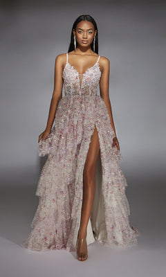 A woman wears the Alyce 61745 Long Prom Dress, a sleeveless, floral-patterned gown with a corset bodice, deep V neckline, and high front slit, standing against a plain gray background.