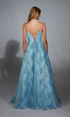 A woman with her back to the camera wears the Alyce 61751 long prom dress in light blue, featuring a lace-up corset bodice with silver embellishments.