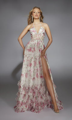 A woman poses against a plain gray background wearing the Alyce 61757 Long Prom Dress—a floor-length, floral-print halter gown with a sheer bodice and high slit.