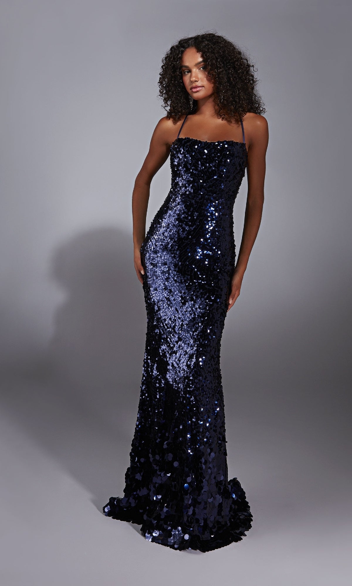 A woman in the Alyce 61758 Strappy-Back Long Sequin Prom Dress poses against a plain gray background.