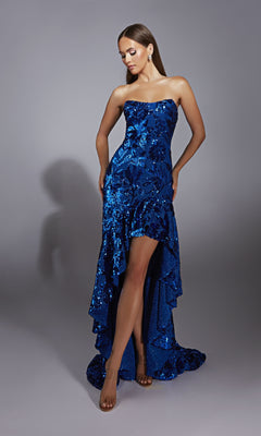 A woman poses against a plain grey background in the Alyce 61760 Long Prom Dress, a royal blue strapless sequin gown featuring a high-low ruffled hem.