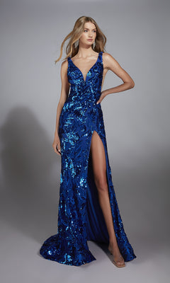 A woman poses elegantly against a plain gray background in the Alyce 61761 Deep V-Back Long Sequin Prom Dress, featuring a sleeveless design, deep blue sequins, a deep V-neckline, and a high thigh slit.