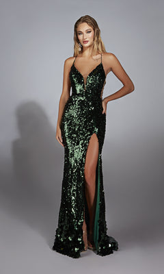 A woman wearing the Alyce 61765 Sleek Long Sequin Prom Dress—a sleeveless, deep green gown with a thigh-high slit—stands against a plain gray background.