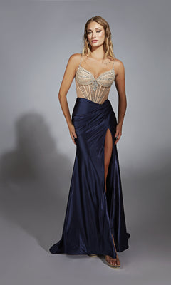 A woman stands in the Long Navy Blue Prom Dress: Alyce 61767, featuring a sleeveless beaded sheer bodice and a dark floor-length skirt with a high leg slit.