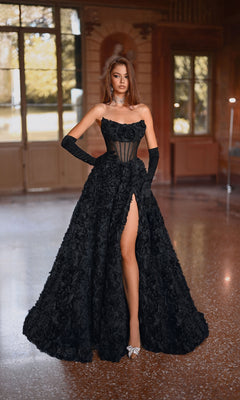 A woman poses gracefully indoors wearing the Alyce 61775 Strapless Rosette Prom Ball Gown, featuring a corset bodice, thigh-high slit, long black gloves, and silver heels in a spacious room with large windows.