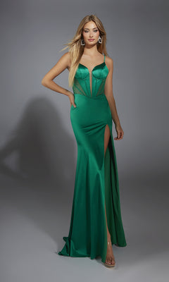 A woman in a fitted emerald green Alyce 61791 Lace-Up Long Corset Prom Dress with thin straps and a high leg slit poses against a gray background.