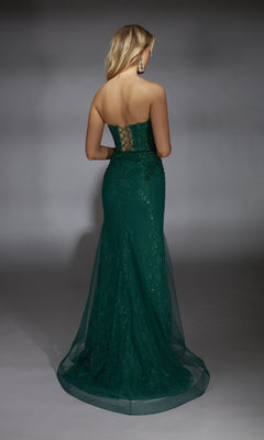 Woman wearing the Alyce 61793 long prom dress—strapless, floor-length, dark green lace with a corset bodice and lace-up back—standing and facing away.