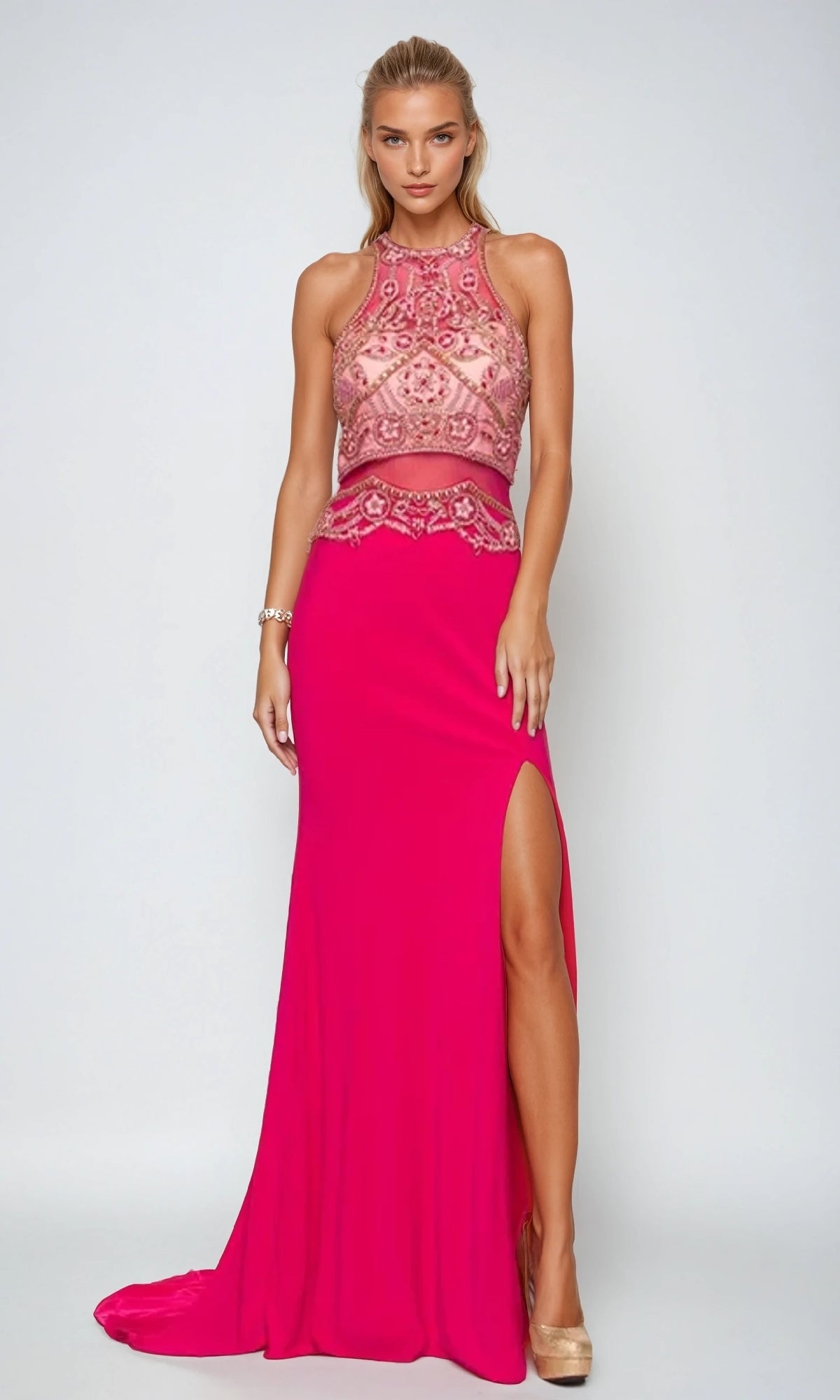 A woman models the Juliet 617 long prom dress, featuring a sleeveless hot pink design with a high neckline, beaded bodice, sheer midsection, and thigh-high slit, paired with beige high heels.