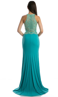 A woman stands with her back to the camera in a Juliet 617 long prom dress, featuring a floor-length turquoise skirt, beaded bodice, and embellished sheer back against a white background.