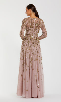 Woman wearing a long, floral embroidered dress on a white background