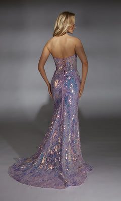 A woman faces away, wearing the Alyce 61862 long prom dress—a strapless, form-fitting lilac mermaid gown with sequins, a lace-up back, and a floor-length lavender design set against a plain gray background.
