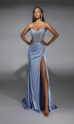 A woman stands with hands on hips against a gray background, wearing the Alyce 61863 Strapless Long Corset Prom Dress in light blue, featuring a rhinestone-beaded bodice and a high thigh slit.