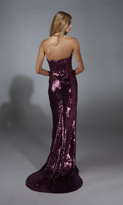 A woman with long blonde hair wears the Alyce 61888 long prom dress, featuring a strapless sequin corset bodice, standing with her back to the camera against a neutral background.