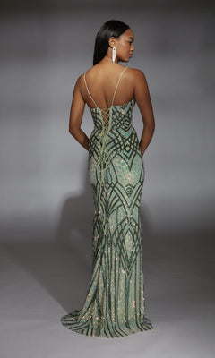 A woman models the Alyce 61919 long prom dress, featuring a green geometric pattern and lace-up back, as she stands facing away from the camera against a neutral background.