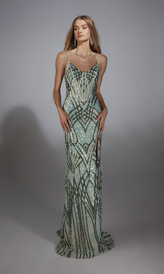 A woman models the Alyce 61920 long prom dress with green, silver, and cream geometric sequins, a corset bodice, high slit, and lace-up back against a plain gray background.