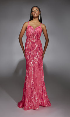 A woman poses against a plain gray background wearing the Alyce 61930 long prom dress, a floor-length, fitted gown with sequins, thin straps, and a plunging neckline.