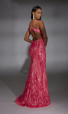 A woman models the Alyce 61930, a floor-length bright pink sequin prom dress featuring a plunging v-neckline, open back, and crisscross straps, as she stands against a neutral gray background.