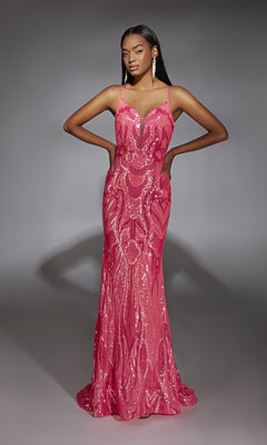 A woman poses with hands on hips in a fitted, floor-length Alyce 61930 sequin prom dress with a plunging neckline, set against a plain gray background.