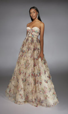 A woman wears the Alyce 61957 long prom dress, featuring a strapless corset bodice and sheer ruffled layers over an A-line skirt, set against a plain gray background.
