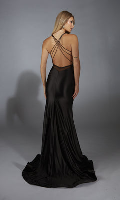 Model wearing the Alyce 61966 long prom dress in black satin, with a v-neckline, thin crisscross straps, and an open back, faces away from the camera against a plain gray background.