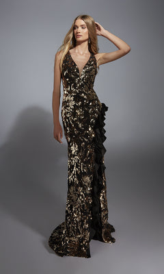 A woman wearing the Alyce 61975 long prom dress with black sequins, gold embellishments, ruffle details, a sleeveless design, and a strappy open back stands against a plain gray background.
