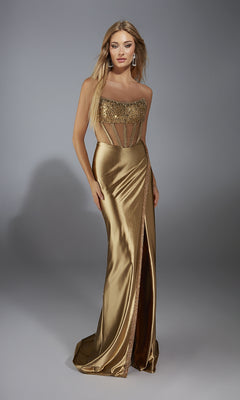 A woman in the Long Prom Dress: Alyce 61976, a gold strapless gown with a sequin corset bodice and thigh-high slit, stands against a plain gray background.