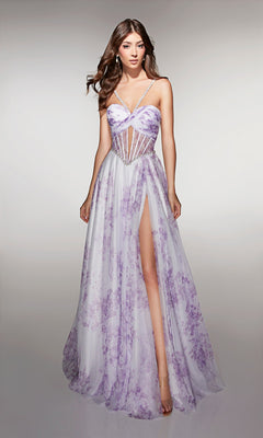 A woman stands against a plain background wearing the Alyce 61994 long prom dress featuring a sleeveless floral design, sheer corset bodice, thin straps, and a high slit.