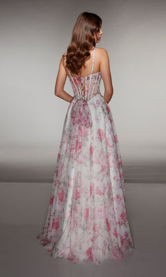 A woman with long brown hair faces away, wearing the Alyce 61994 Long Prom Dress by Alyce Paris—a stunning floral gown with a fitted corset-style bodice and thin straps.