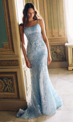 A woman stands indoors wearing the Alyce 62017 long prom dress in Glacier Blue/White, featuring a floor-length fitted silhouette and thin straps, looking down with her hands at her sides.