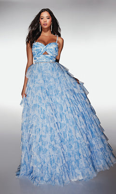 A woman wears the Alyce 62018 long prom dress—light blue, patterned, with thin straps, a waist cutout, and tiered layers—standing against a plain white background.