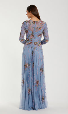 A woman facing away, wearing the Mac Duggal 6202 long formal dress in light blue, featuring sheer sleeves and intricate floral embroidery, stands against a plain light background.