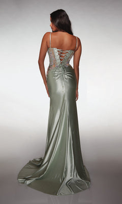 A woman stands facing away, wearing the Alyce 62022 long prom dress—a shimmery light green, sleeveless gown with a corset bodice, lace-up back, and flowing train.