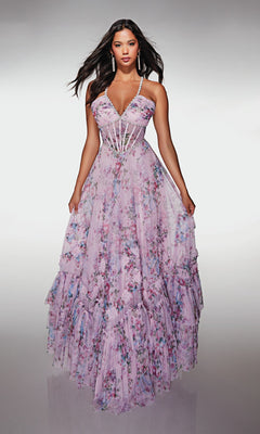 Woman wearing the Alyce 62028 long prom dress in lavender floral print, featuring a sheer corset bodice, thin straps, and a flowing layered A-line skirt, stands against a plain background.