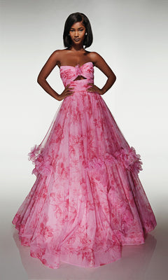 A woman stands in the Alyce 62042 long prom dress, a strapless pink floral ballgown featuring a fitted bodice with cut-out detail and a full ruffle skirt adorned with layered ruffles.