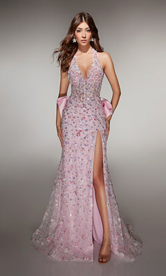 A woman stands against a neutral background in the Alyce 62044 long pink prom dress, featuring sequin embellishments, sleeveless design, deep V-neckline, high slit, and a satin bow at the back.
