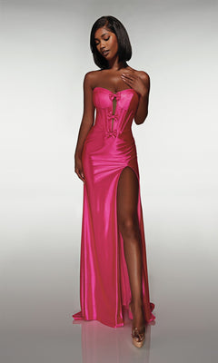 A woman in the Alyce 62046 long prom dress—strapless, metallic, with a corset bodice and thigh-high slit—stands against a plain light background wearing clear high heels.