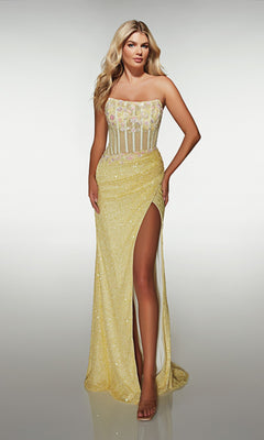 A woman stands against a plain light background in the Alyce 62047 long prom dress, featuring a strapless yellow design with a sheer floral bodice, delicate floral appliques, and a high slit.