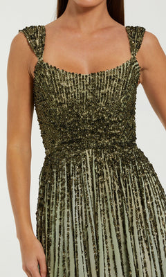 A woman wears the Mac Duggal 6205 long formal dress, a sleeveless, square-neck evening gown adorned with green and gold sequins in vertical lines.