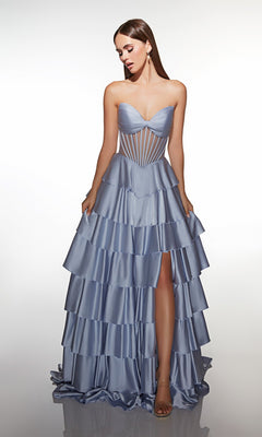 A woman wears the Alyce 62056 long prom dress in French Blue, featuring a strapless satin sweetheart neckline, corset-style bodice, and tiered ruffle A-line skirt with a high slit, standing against a plain white background.