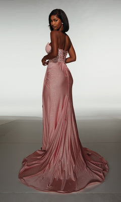 A woman stands with her back to the camera, wearing the Alyce 62057 long formal dress—a strapless, floor-length pink gown with a lace-up back—set against a plain background.