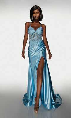 A woman poses in the Alyce 62059 long formal dress, featuring light blue satin, a sheer embellished corset bodice, and a high slit, capturing the modern allure of this standout prom gown against a plain background.