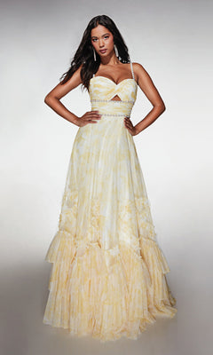 A woman stands with hands on hips, wearing the Alyce 62063 long formal dress featuring a strapless yellow design with ruffles and a fitted, embellished bodice against a plain background.